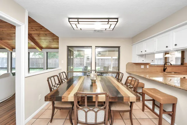 a view of a dining room with furniture a chandelier and wooden floor