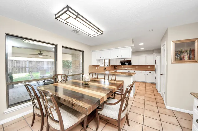 a dining room with furniture and a view of kitchen