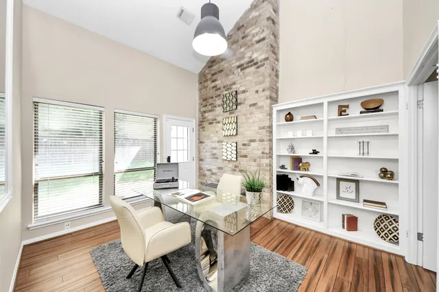 a living room with furniture and a book shelf
