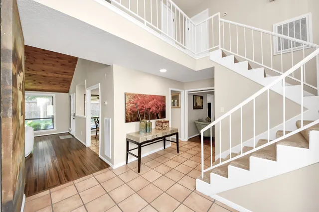 a view of entryway and hall with wooden floor