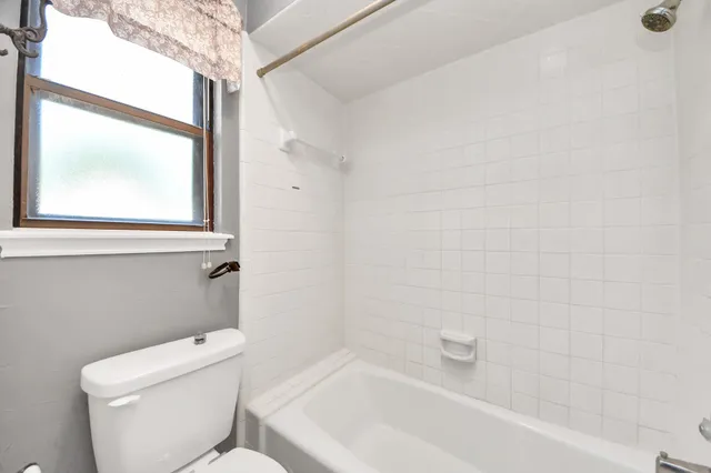 a bathroom with a toilet and a bathtub