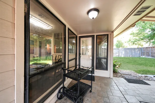 a aerial view of a house with a yard table and chairs