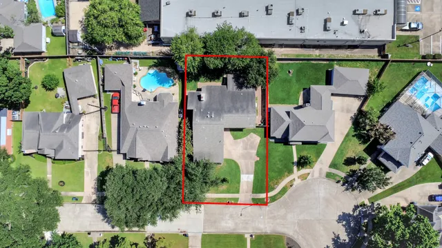 a view of house with a yard and potted plants