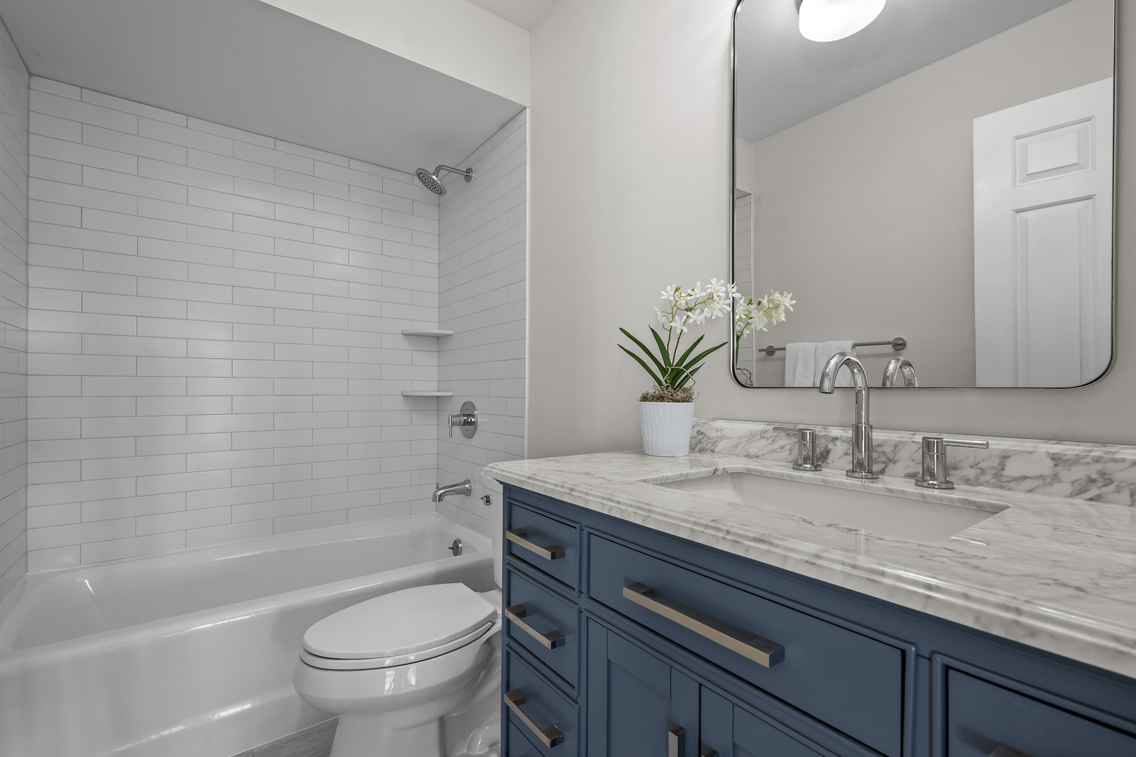 1250 Rudolph Drive, Unit 4F Northbrook, IL 60062 - Photo 13 of 15 a bathroom with a granite countertop sink a toilet and bathtub