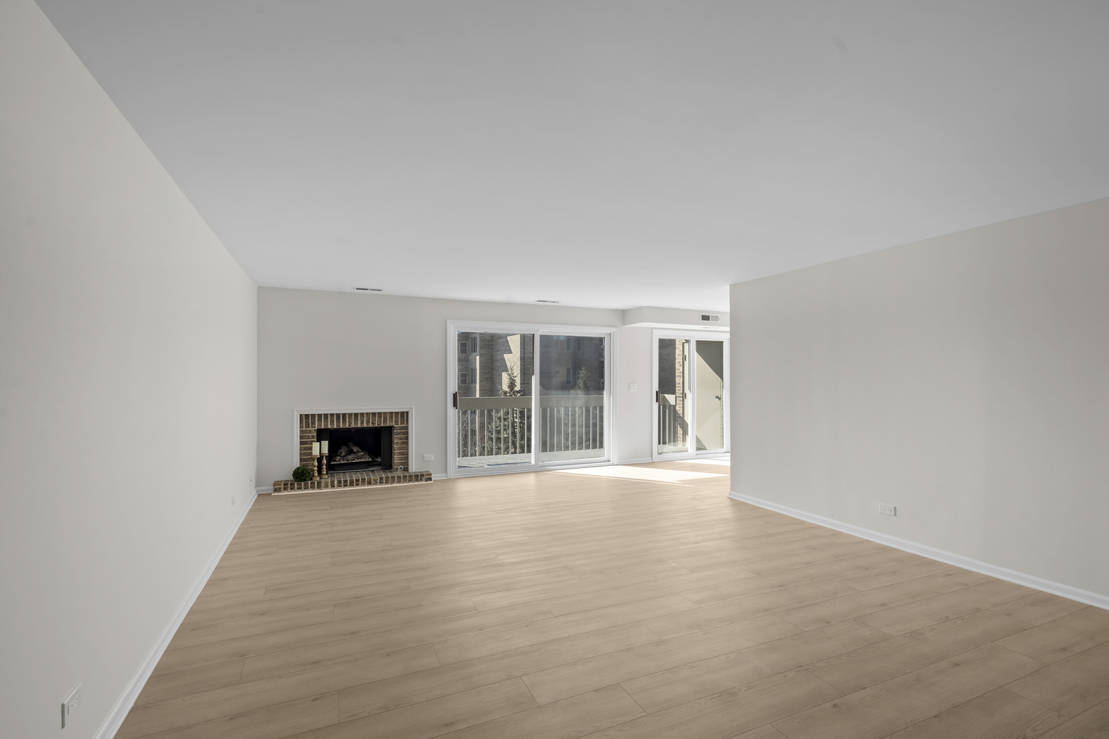 1250 Rudolph Drive, Unit 4F Northbrook, IL 60062 - Photo 5 of 15 an empty room with floor to ceiling window and fireplace
