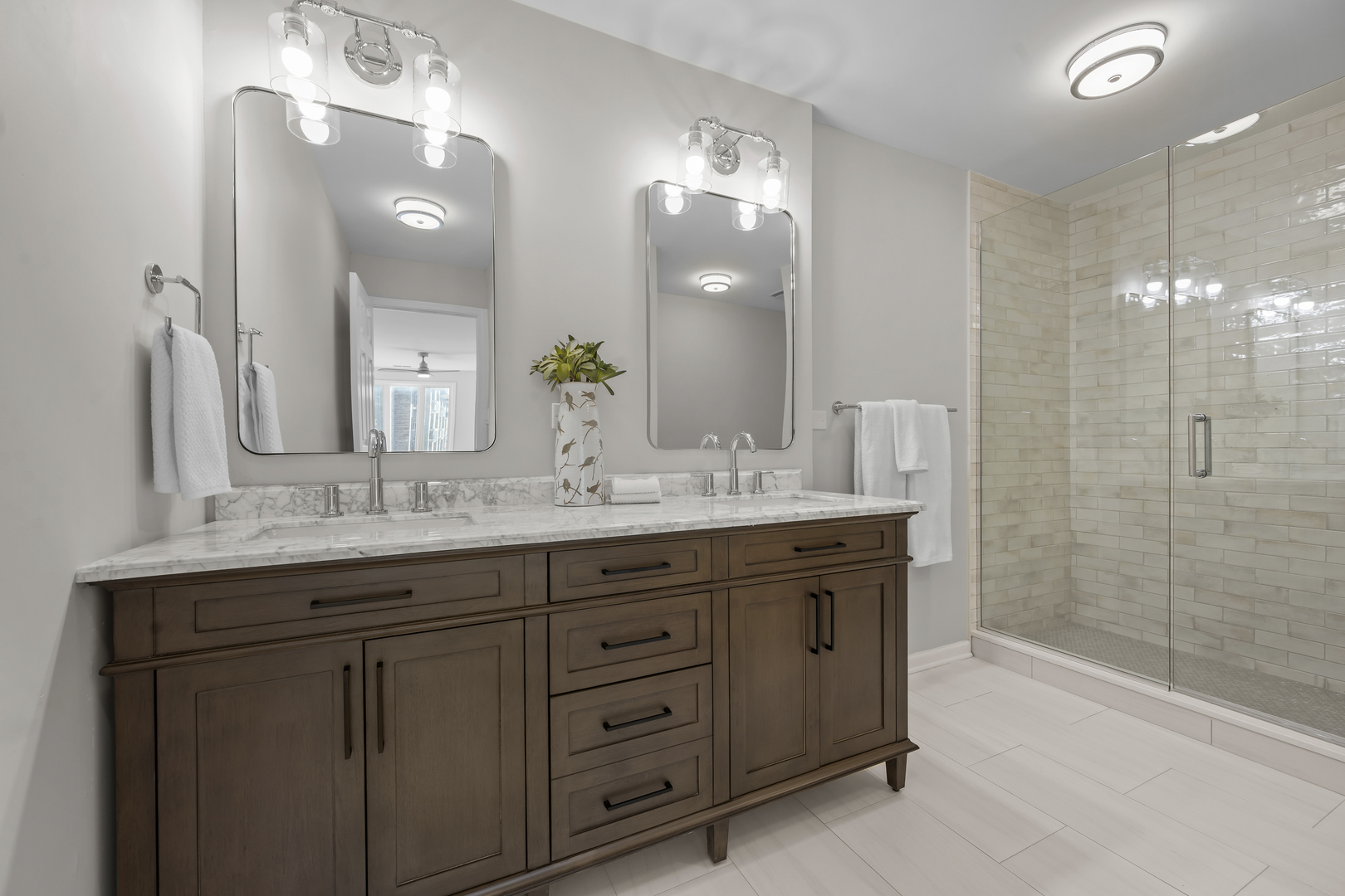 1250 Rudolph Drive, Unit 4F Northbrook, IL 60062 - Photo 9 of 15 a bathroom with double vanity sink and a mirror