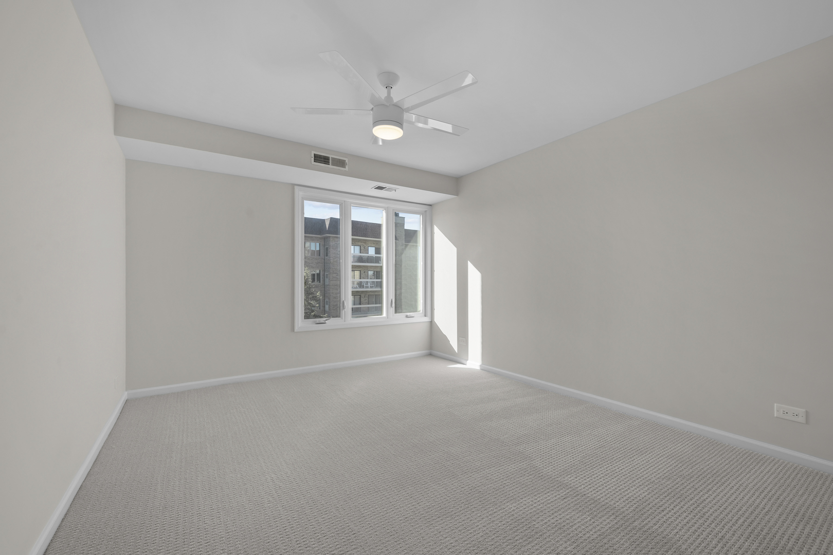 1250 Rudolph Drive, Unit 4F Northbrook, IL 60062 - Photo 10 of 15 a view of an empty room with a window