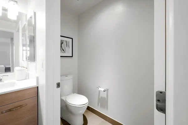 a white toilet sitting next to a bathroom sink