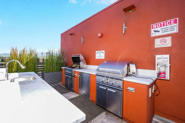 a kitchen with stainless steel appliances granite countertop a stove a sink and a refrigerator
