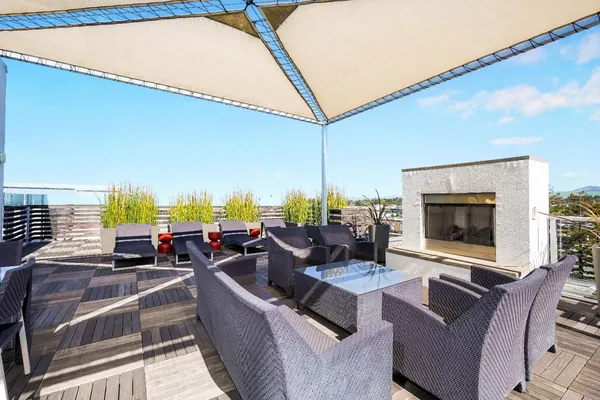 a living room with furniture a flat screen tv and a floor to ceiling window