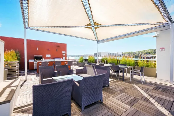 a view of a roof deck with table and chairs