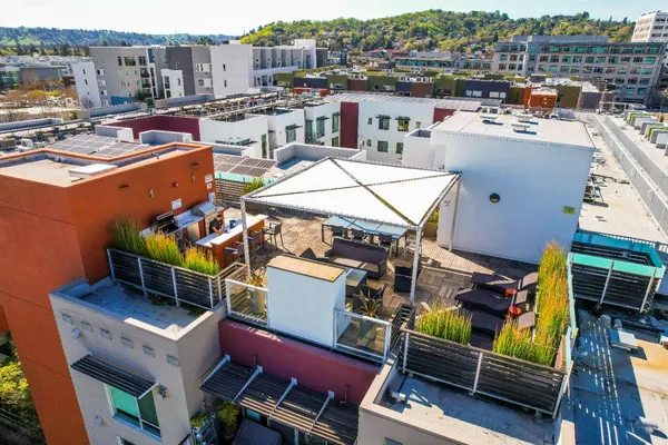 a roof deck with table and chairs