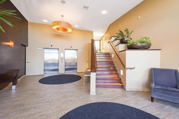 a view of entryway and hall with wooden floor
