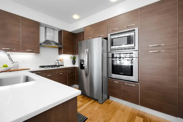 a kitchen with a refrigerator and a sink