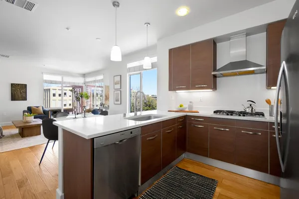 a kitchen with sink stove and cabinets