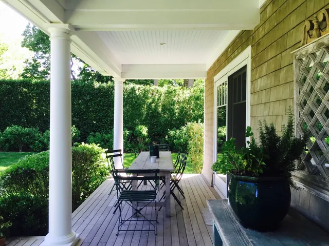 a view of balcony with furniture and garden