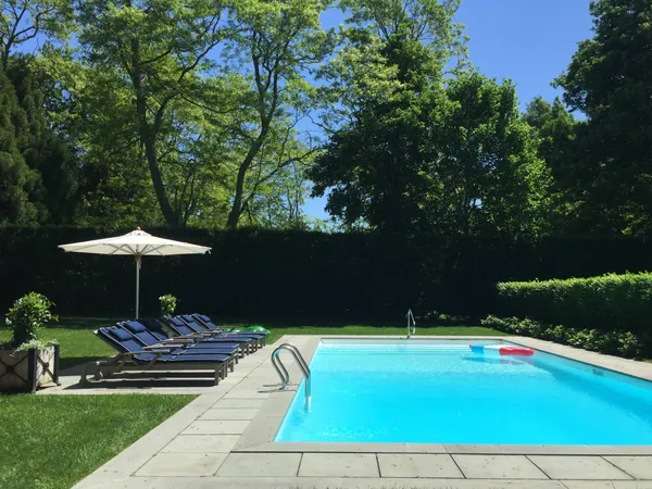 a view of a swimming pool and lounge chairs