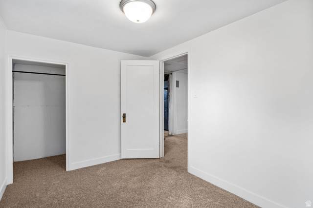141 South 400 East Logan, UT 84321 - Photo 27 of 41 Unfurnished bedroom featuring light carpet and a closet