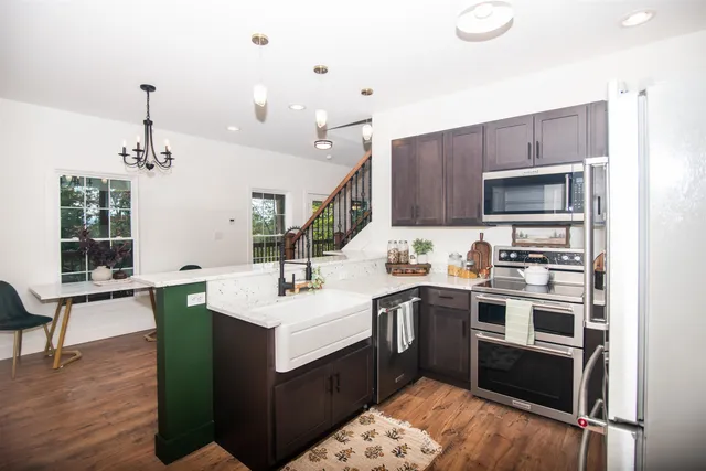 a kitchen with a sink a counter space and appliances