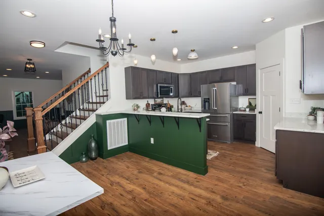 a living room with fireplace furniture and a wooden floor