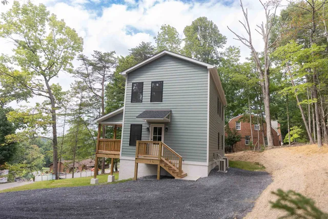 a view of house with front door and outdoor seating
