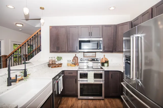 a kitchen with sink cabinets and wooden floor