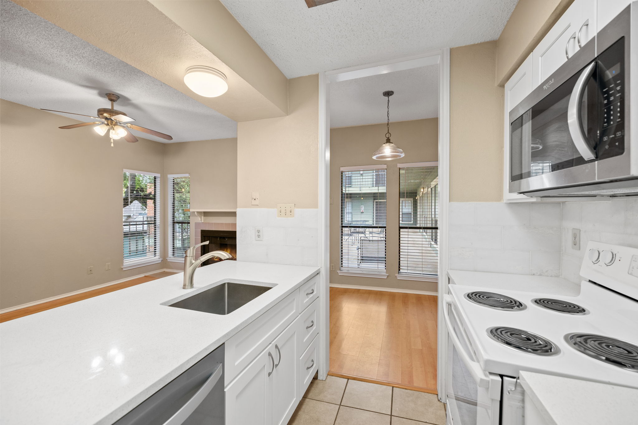 2706 Salado Street, Unit 210 Austin, TX 78705 - Photo 13 of 32 a kitchen with a sink cabinets and stainless steel appliances
