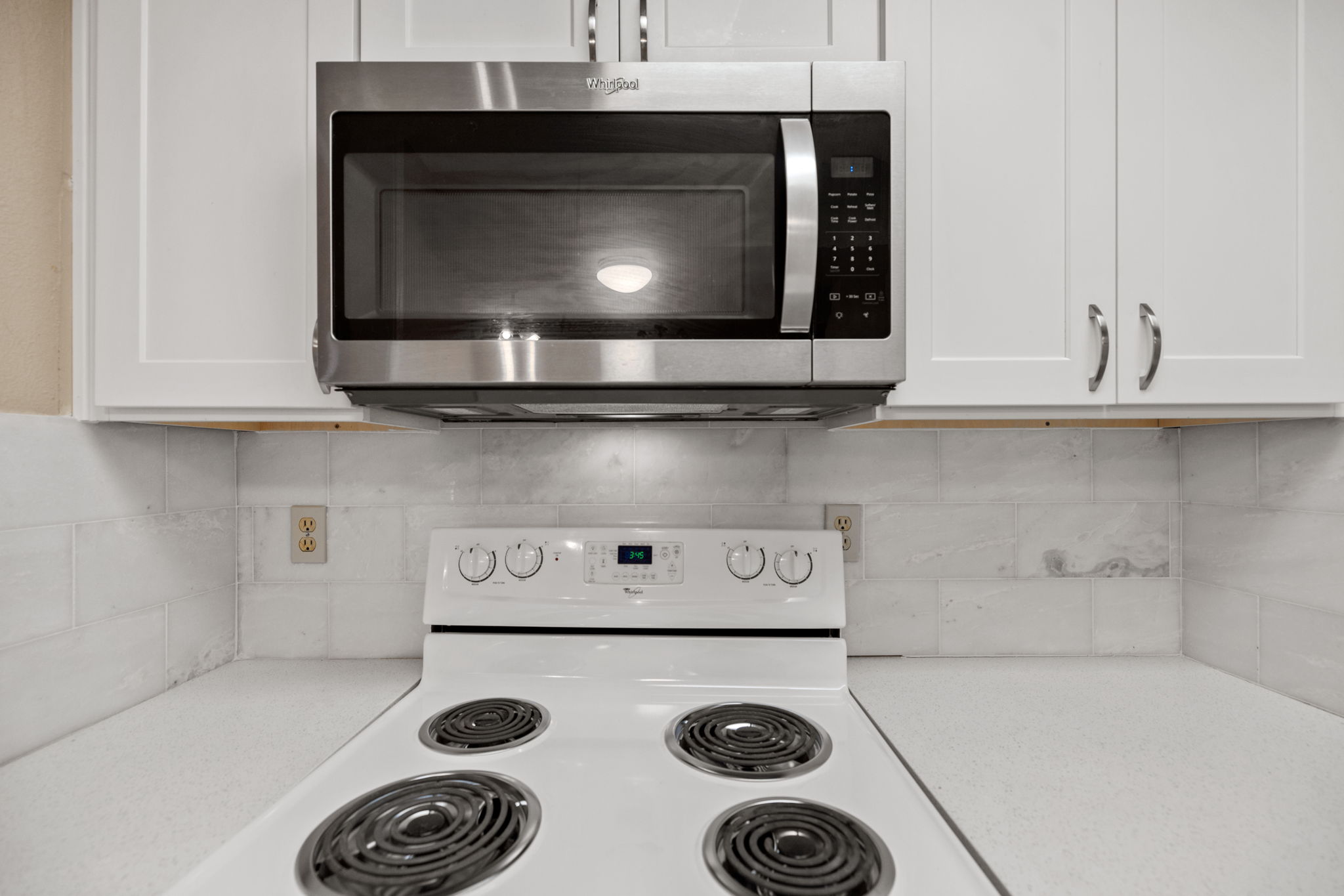 2706 Salado Street, Unit 210 Austin, TX 78705 - Photo 14 of 32 a kitchen with a stove and a microwave