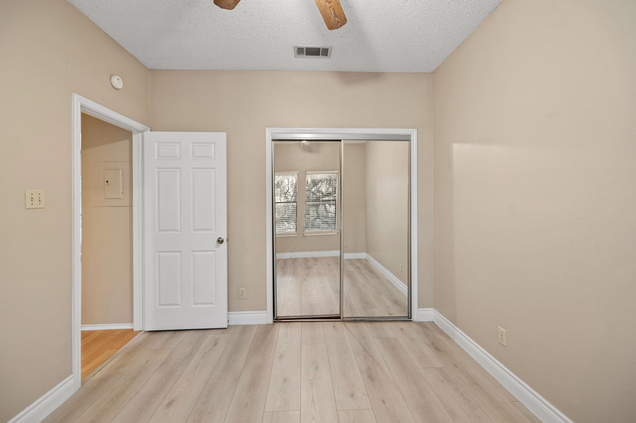 2706 Salado Street, Unit 210 Austin, TX 78705 - Photo 20 of 32 an empty room with closet and windows