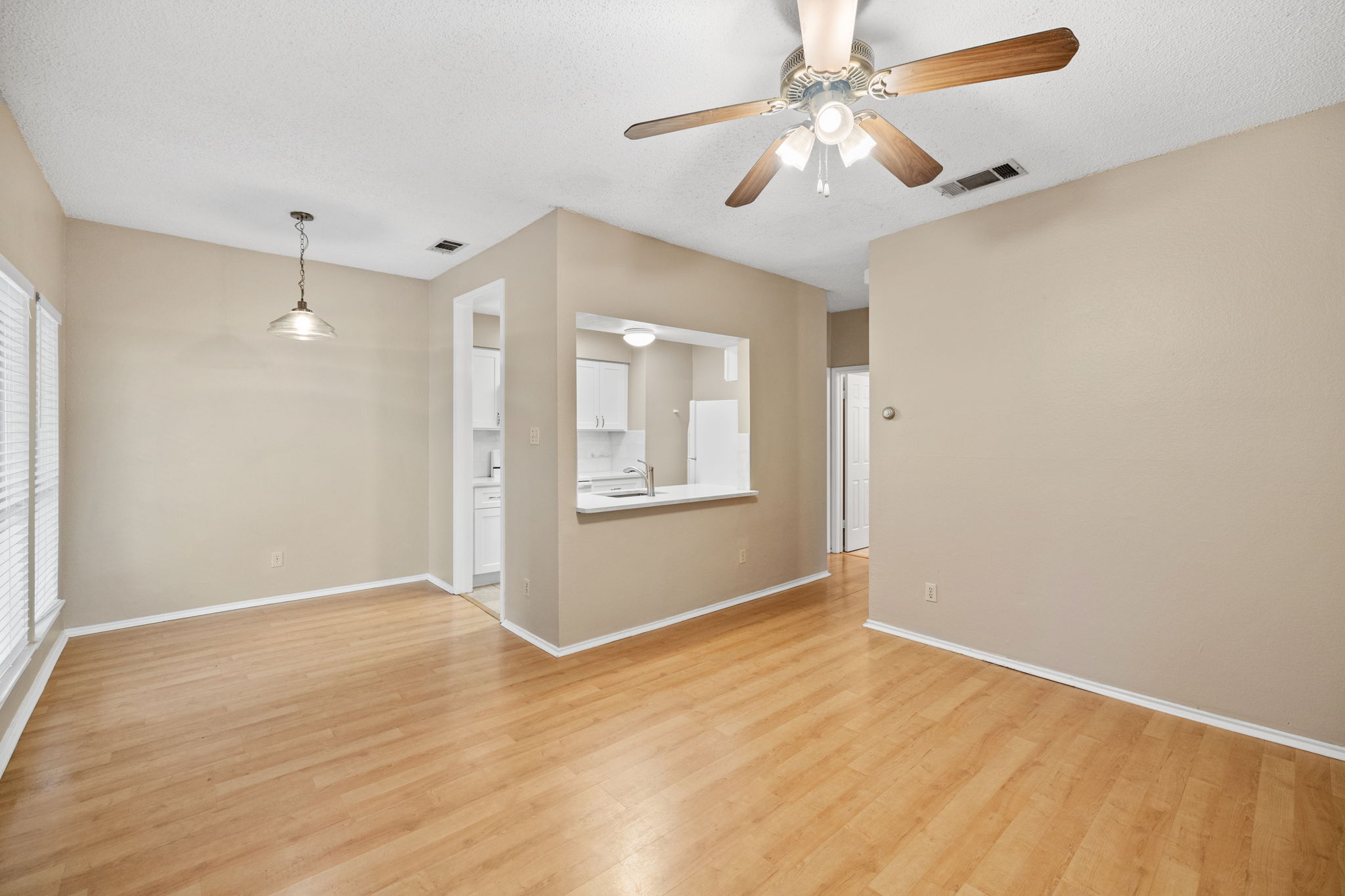 2706 Salado Street, Unit 210 Austin, TX 78705 - Photo 23 of 32 a view of an empty room with window and chandelier fan