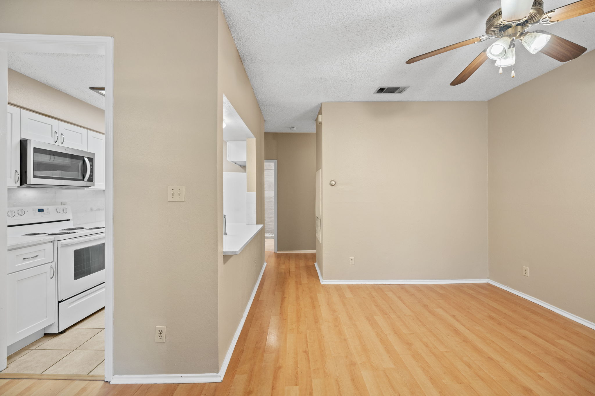 2706 Salado Street, Unit 210 Austin, TX 78705 - Photo 24 of 32 a view of a kitchen with wooden floor and electronic appliances