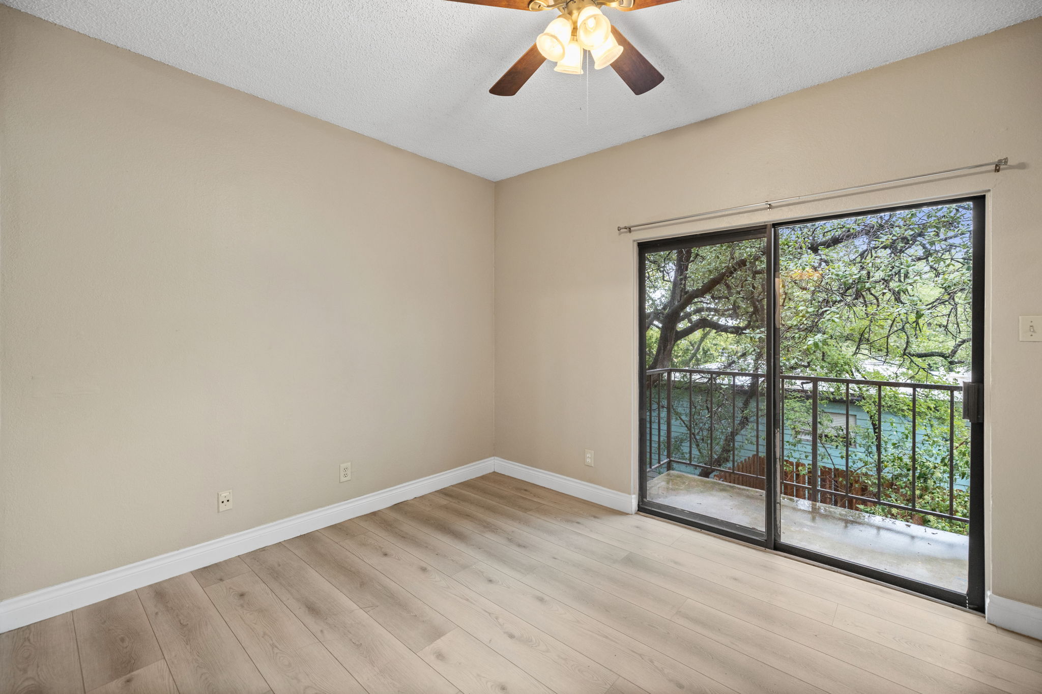 2706 Salado Street, Unit 210 Austin, TX 78705 - Photo 26 of 32 a view of a room with wooden floor and balcony