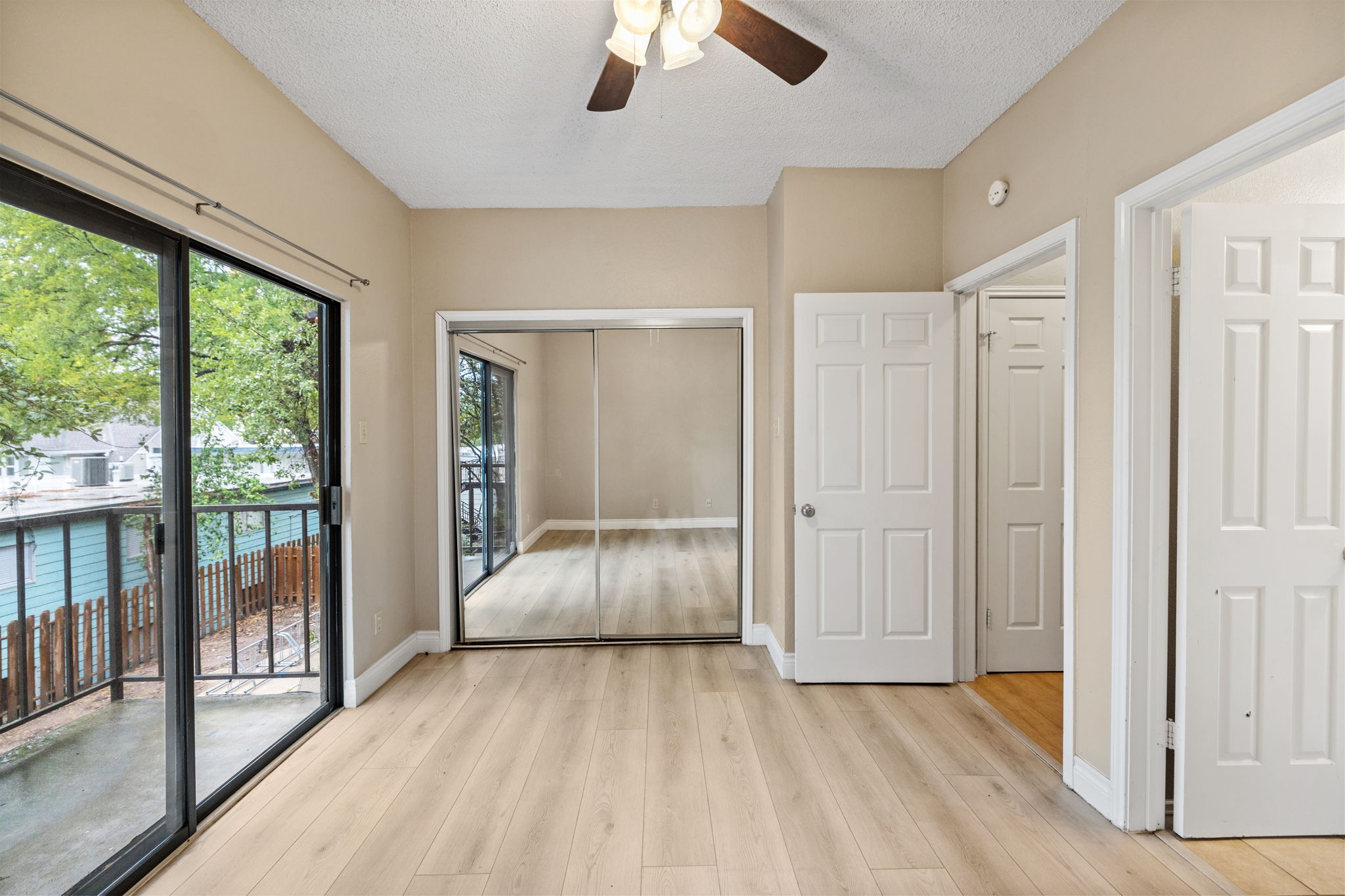 2706 Salado Street, Unit 210 Austin, TX 78705 - Photo 27 of 32 a view of empty room with wooden floor and fan