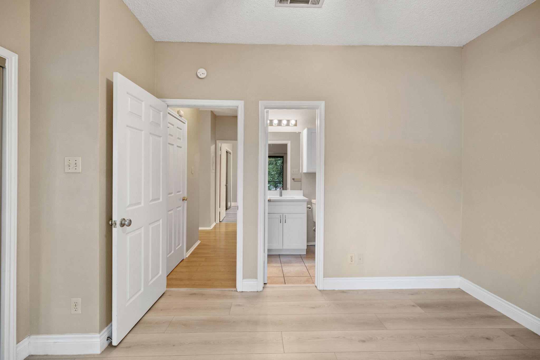 2706 Salado Street, Unit 210 Austin, TX 78705 - Photo 28 of 32 a view of a hallway with wooden floor and closet