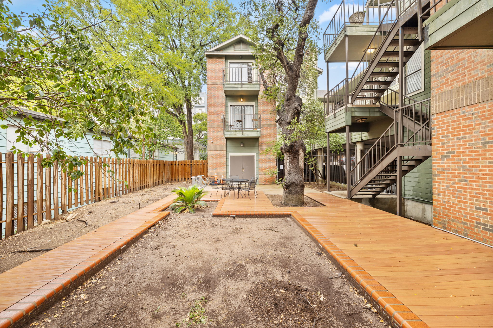 2706 Salado Street, Unit 210 Austin, TX 78705 - Photo 3 of 32 a view of a house with backyard and sitting area