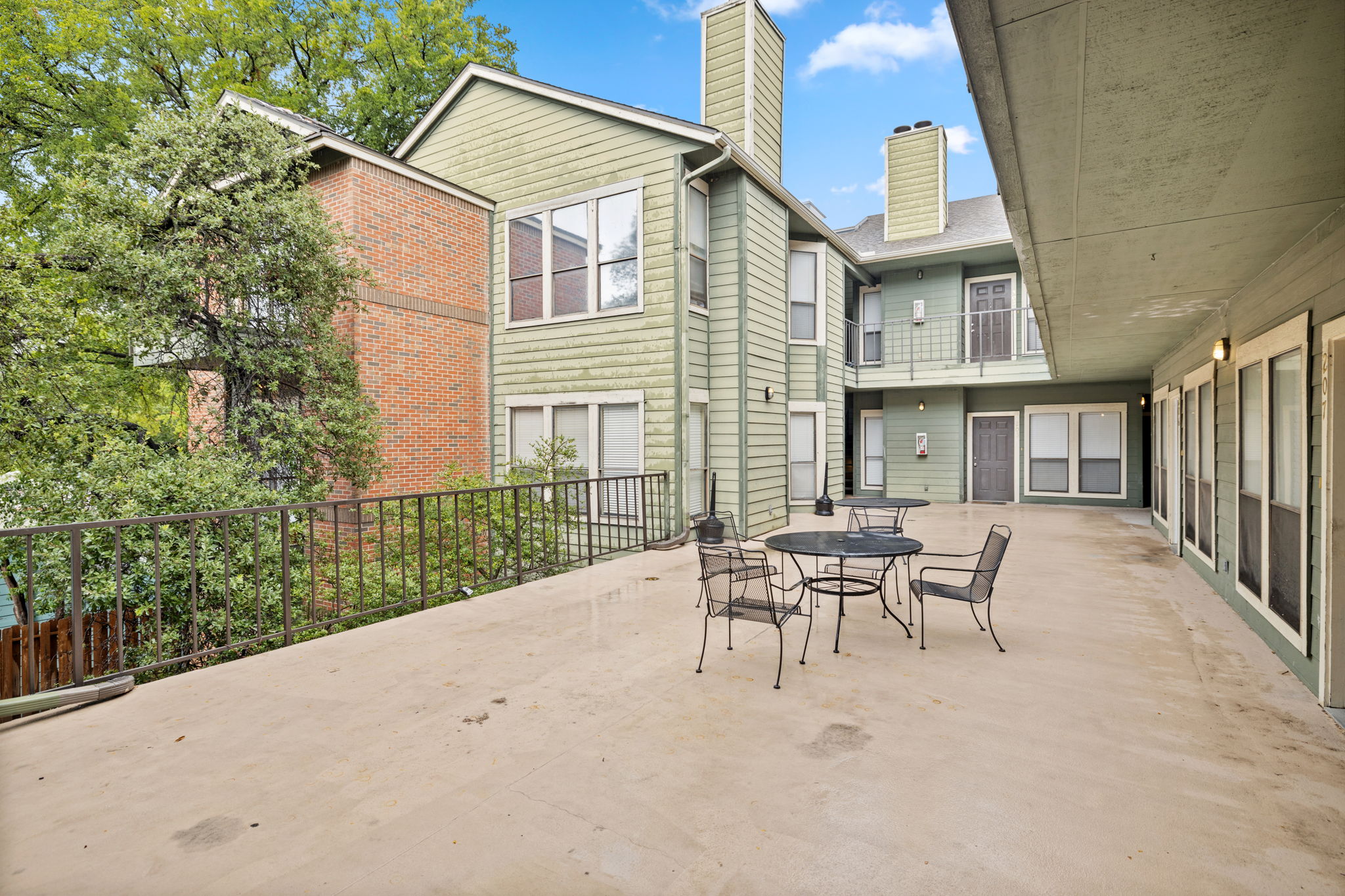 2706 Salado Street, Unit 210 Austin, TX 78705 - Photo 5 of 32 a patio with a table and chairs and potted plants
