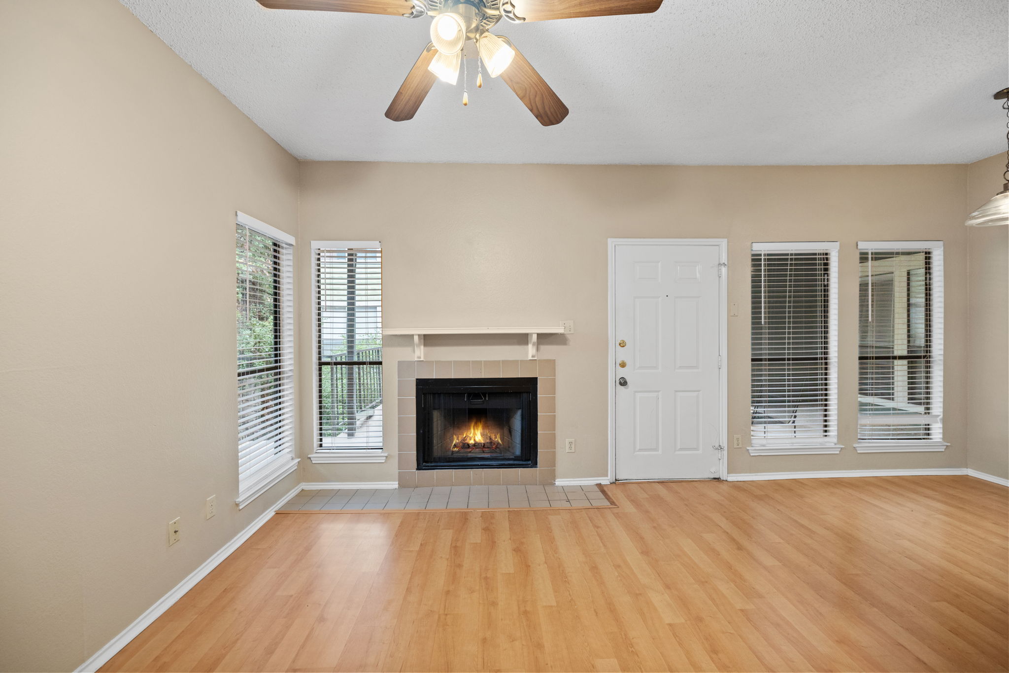 2706 Salado Street, Unit 210 Austin, TX 78705 - Photo 7 of 32 a view of an empty room with wooden floor fireplace and a window