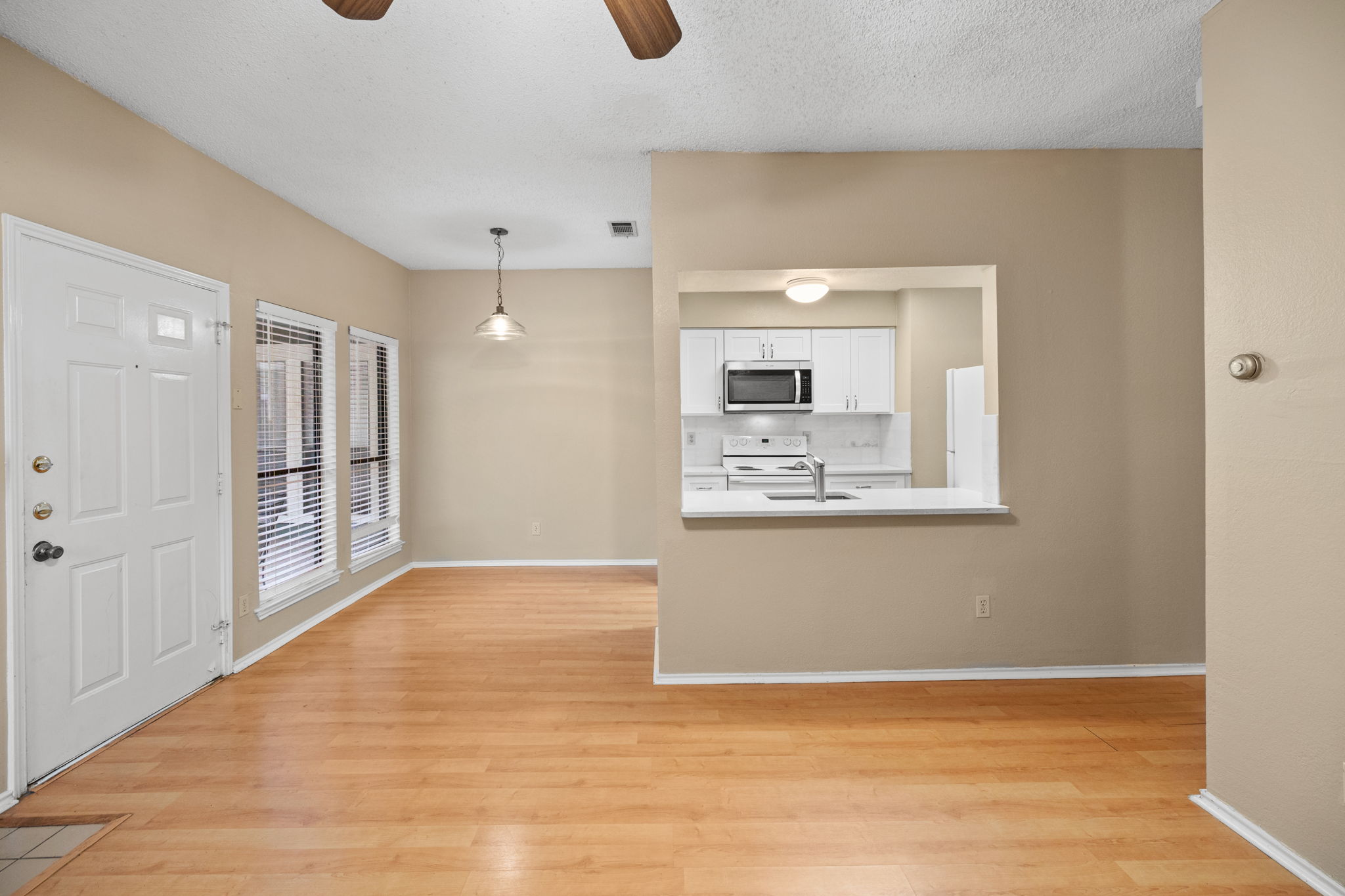 2706 Salado Street, Unit 210 Austin, TX 78705 - Photo 8 of 32 a view of an empty room with wooden floor and a window