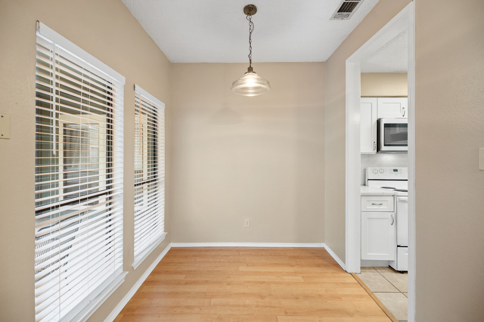 2706 Salado Street, Unit 210 Austin, TX 78705 - Photo 10 of 32 a view of a room with a door and wooden floor