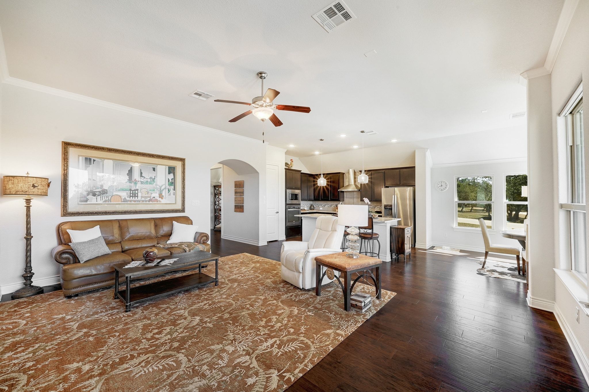 960 Blue Ridge Drive Dripping Springs, TX 78620 - Photo 5 of 38 Living room with crown molding, arched walkways, dark wood-type flooring, ceiling fan, and recessed lighting