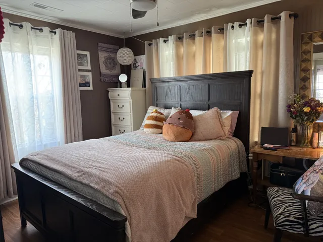 a bedroom with a bed and a window