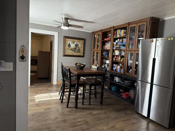 a view of a dining room with furniture and wooden floor