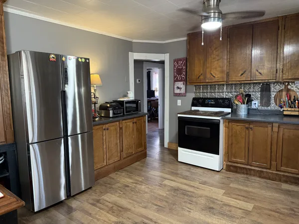 a kitchen with stainless steel appliances a refrigerator sink and cabinets