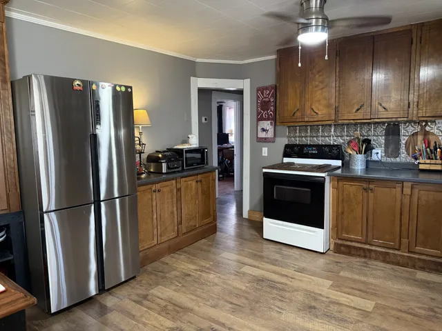 a kitchen with stainless steel appliances a refrigerator sink and cabinets