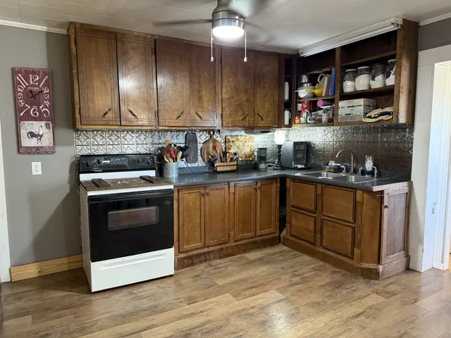 a kitchen with stainless steel appliances granite countertop a stove a sink and a refrigerator