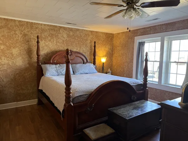 a bedroom with a bed and a chandelier