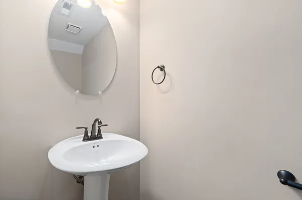 a bathroom with a sink a mirror and shower curtain