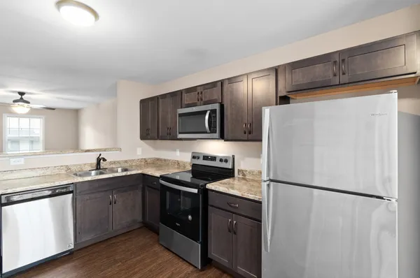 a kitchen with a refrigerator sink and microwave