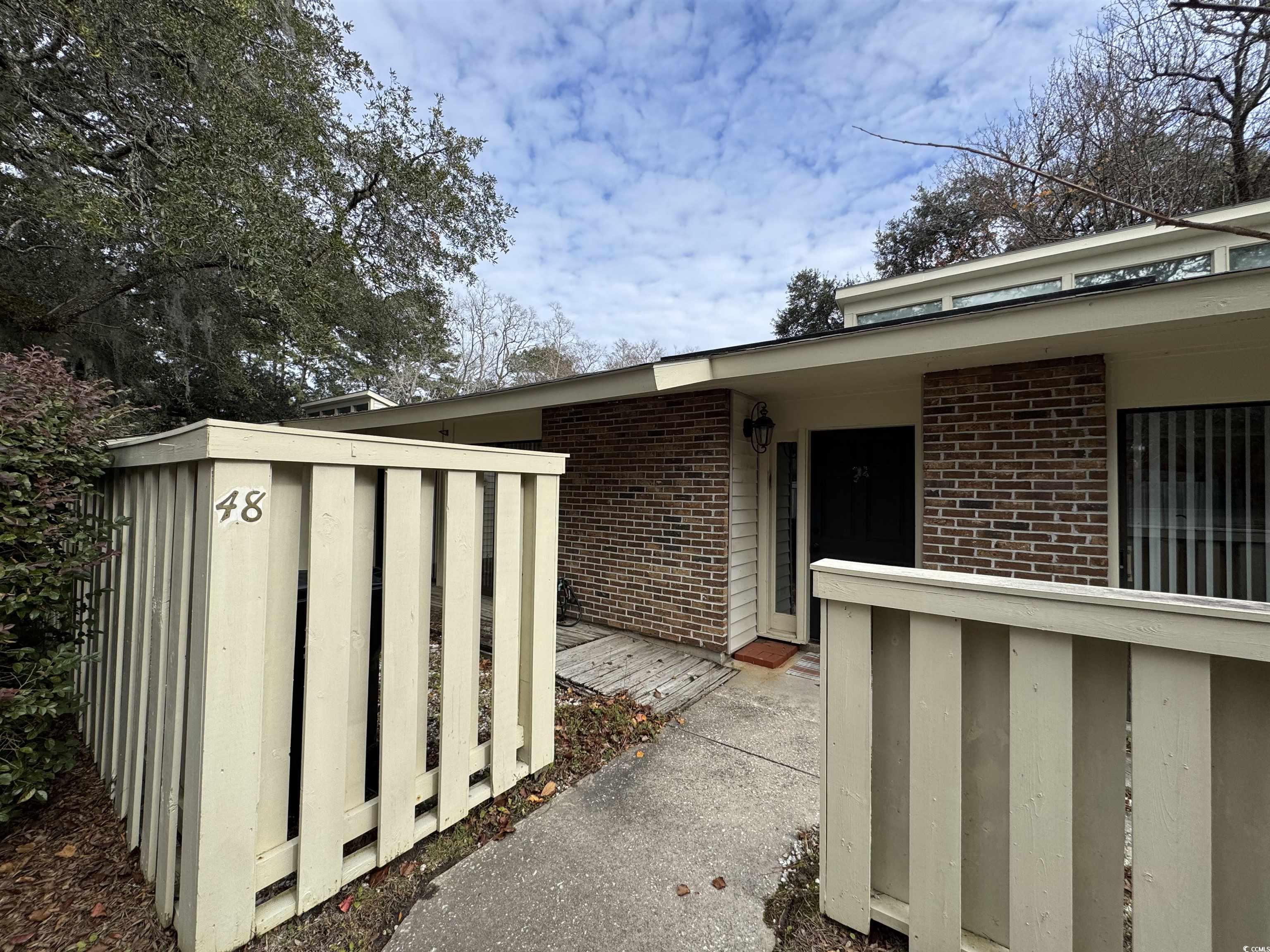 58 Wedgefield Village Road, Unit 48 Georgetown, SC 29440 - Photo 2 of 23 View of exterior entry with brick siding