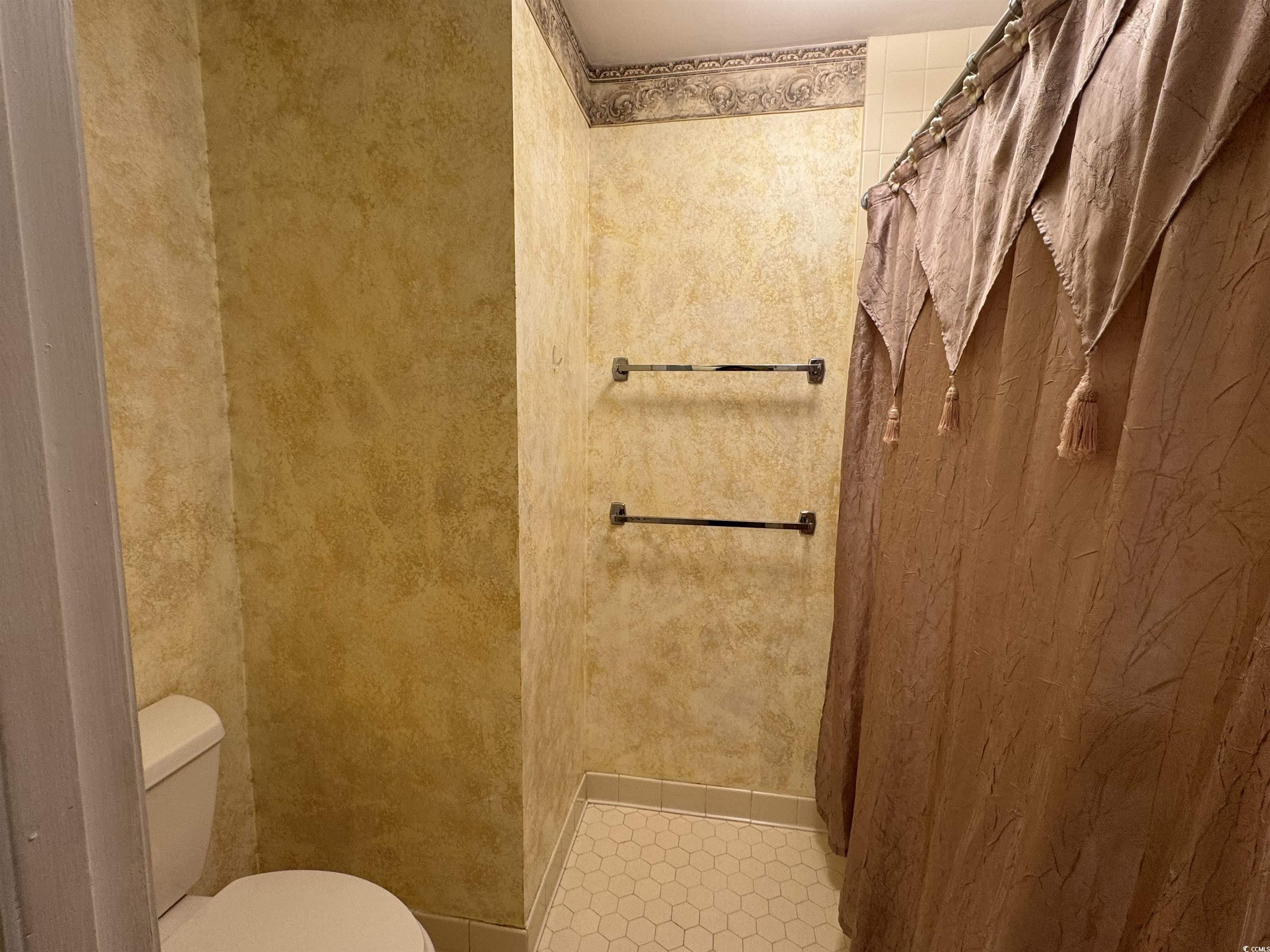 58 Wedgefield Village Road, Unit 48 Georgetown, SC 29440 - Photo 23 of 23 Bathroom featuring curtained shower and toilet